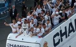 Real Madrid players parade the Champions League trophy on an open top bus after they won it for the 15th time at Wembley on Saturday