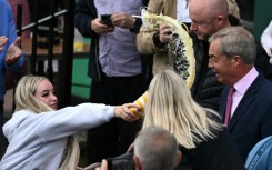 A 25-year-old woman doused Nigel Farage with a milkshake at his inaugural campaign rally