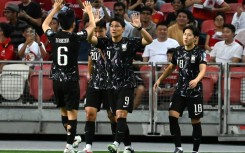 South Korea's Joo Min-kyu (centre) celebrates scoring against Singapore