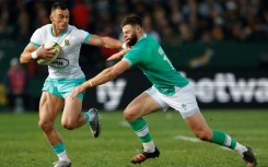 South African Jesse Kriel (L) hands off fellow centre Robbie Henshaw of Ireland during the first Test in Pretoria.
