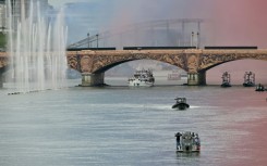 The delegation from Greece sails under Pont d'Austerlitz as the first of the teams to go down the River Seine in the Olympics opening ceremony