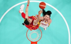 Spain's Megan Gustafson  and China's Li Yueru go for a rebound in basketball