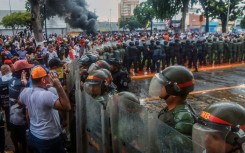 Demonstrators confront riot police during a protest against Venezuelan President Nicolas Maduro's government in Puerto La Cruz on July 29, 2024