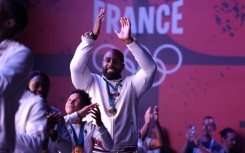 Teddy Riner and the gold medal-winning French judo team celebrate with supporters at Club France