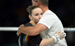 Romanian gymnast Ana Barbosu with her coach during the Paris Olympics