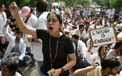 Medical professionals and students shout slogans in New Delhi on August 16, as they protest the rape and murder of a doctor