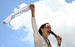 Venezuelan opposition leader Maria Corina Machado speaks to supporters while holding up electoral records during a rally in Caracas on August 28, 2024