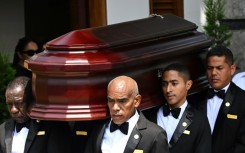 Employees from a funeral parlour carry the coffin of late Peru's former president Alberto Fujimori 