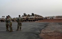 Military vehicles that will be boarded onto a cargo plane as part of US troops' departure from Niger are seen in Niamey in June 2024 