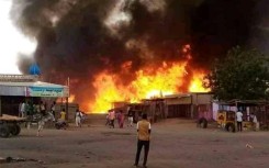 Fire rages in a livestock market area of El-Fasher, North Darfur, on September 1, 2023, as Sudan's war spread to the city