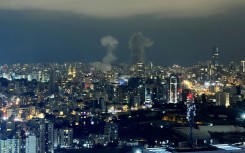 Smoke plumes rise from the site of two Israeli air strikes in the central area of Beirut