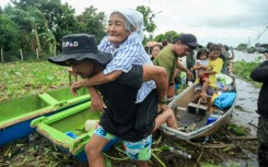 In Bato municipality, residents waited for rescuers as the floodwaters left only the roofs of houses visible