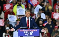 Republican presidential nominee Donald Trump holds a press conference from inside trash hauler at Green Bay Austin Straubel International Airport on October 30, 2024 in Green Bay, Wisconsin