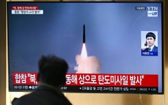 A man watches a a news broadcast with file footage of a North Korean missile test at a train station in Seoul on Thursday