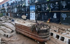 This picture taken on November 1, 2024 shows a coffin covered in mud and debris at a cemetery in the town of Alfafar