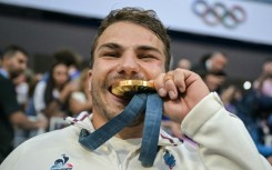Antoine Dupont celebrates with his Olympic gold medal in July