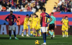 Barcelona's Brazilian forward Raphinha (R) reacts after Las Palmas scored their first goal