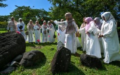 Women prayed for relatives who lost their lives in the 2004 Indian Ocean tsunami at a mass grave in Indonesia