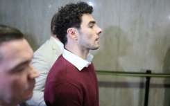 Luigi Mangione wore a white shirt, burgundy sweatshirt and was shackled during his appearance