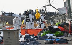 Firefighters and rescue personnel working after the Jeji Air crash