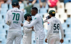 Pakistan's Mohammad Rizwan (CL) congratulates South Africa's Kagiso Rabada (CR) after he steered the hosts to victory in a nailbiting climax to the first Test