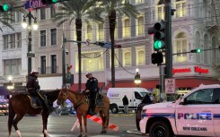 Police cordon off the intersection of Canal Street and Bourbon Street in the French Quarter of New Orleans, Louisiana after a driver rammed a truck into a crowd, killing at least 10.