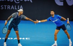 Australia’s Nick Kyrgios (L) and Serbia’s Novak Djokovic (R) lost in the doubles at the Brisbane Interational