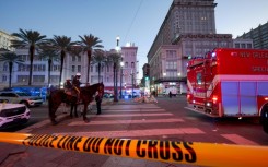 Early morning on New Year's Day as police cordon off the intersection of Canal Street and Bourbon Street in New Orleans after a truck plowed into a crowd of revellers, killing at least 15 people