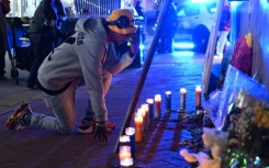 A mourner reacts at a memorial on New Orlean's Bourbon Street on January 2, 2025 one day after a man drove a truck into the crowded street, killing 14 people