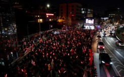 Supporters of deposed South Korean president Yoon Suk Yeol demonstrate near his residence brandishing glowsticks