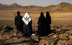 Local residents watch as cars, motorbikes and truck drivers got their 2025 Dakar Rally campaign underway in Bisha, Saudi Arabia 