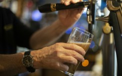 A bartender pours a draft beer in a bar in Brest, western France