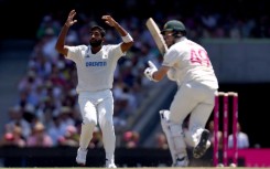 India’s captain Jasprit Bumrah (L) reacts after Australia’s Steve Smith hit a shot during day two of the fifth Test