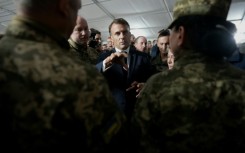 French President Emmanuel Macron speaks with Ukrainian soldiers during a visit to a military camp in eastern France in October, 2024