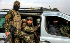 Fighters loyal to the interim Syrian government, in the Zahra district of Homs