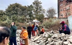 People gather in an open area of Nepal's capital Kathmandu after feeling the powerful tremor in neighbouring Tibet
