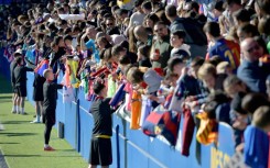 Barcelona's Spanish forward Dani Olmo and teammates sign autographs for fans at an open training session