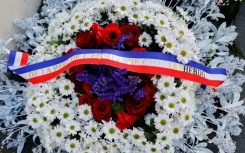French President Emmanuel Macron and Paris Mayor Anne Hidalgo both laid wreaths near the publication's former offices