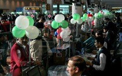 Passengers wait to board their Pakistan International Airlines (PIA) flight to Paris after EU authorities lifted a four-year ban on the flag carrier