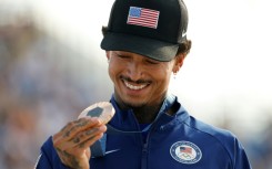 Nyjah Huston holds his bronze medal after the victory ceremony for the men's street skateboarding event on July 29, 2024