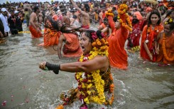 Sadhvis or Hindu holy women take part in a mass bathing ritual in Sangam
