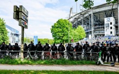 Police forces stand guard outside the Volksparkstadion in Hamburg. 