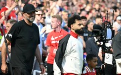 Jurgen Klopp walks out with Mohamed Salah before the German's final match in charge of Liverpool last May
