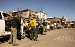 Private firefighters stand watch at property opwned by billionaire developer Rick Caruso