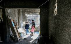 Ahmad Kafozi and his children are staying with relatives because their home is too badly damaged