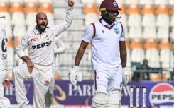Pakistan's Sajid Khan celebrates after taking the wicket of West Indies' Keacy Carty (R) during the second day of the first Test at Multan