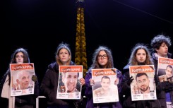 Some of those present carried photos of the hostages under a sign saying 'abducted'