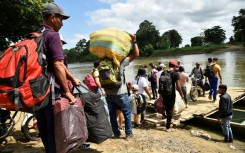 Displaced people from recent clashes between armed groups cross the Tarra River, which divides Colombia and Venezuela, in Tibu, Colombia on January 19, 2025