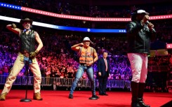 Trump looks on as the Village People perform at the MAGA victory rally at the Capital One Arena in Washington