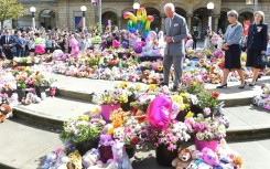 Britain's King Charles III views tributes placed outside Southport Town Hall following the July 29, 2024 attack at a childrens' Taylor Swift themed dance party